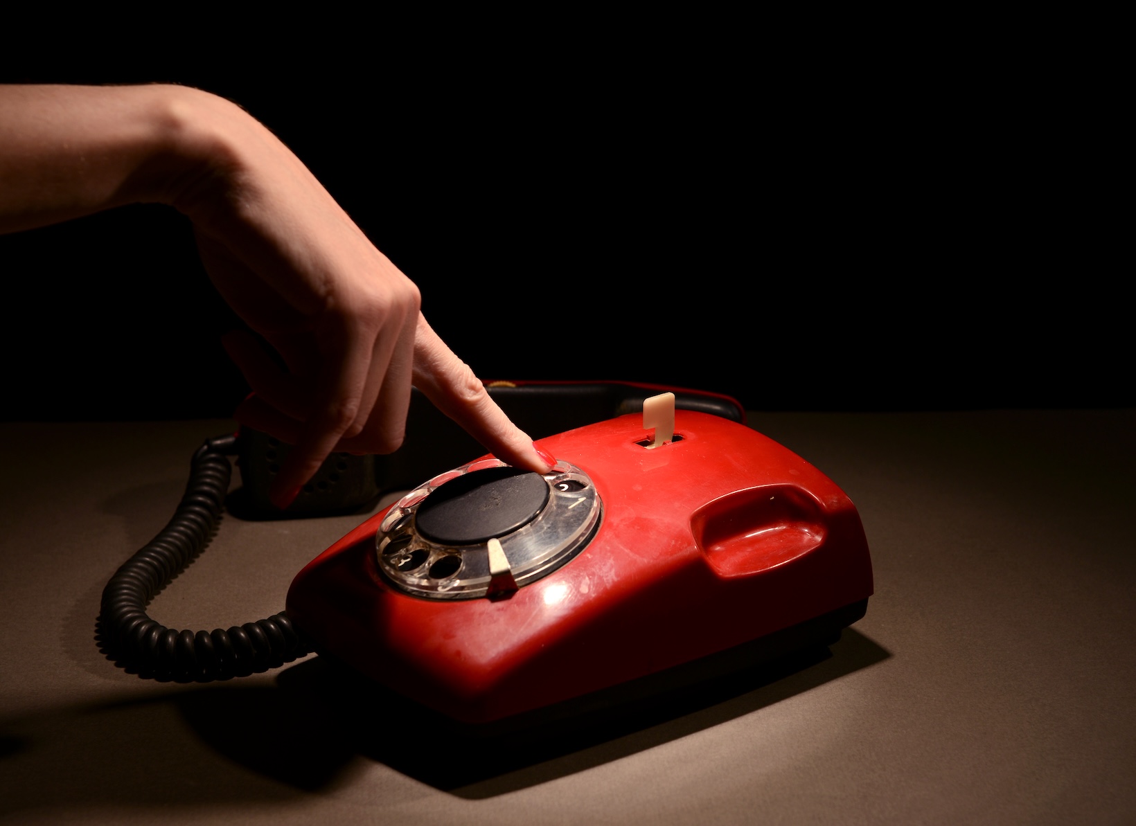 Red retro telephone,on dark background